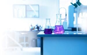 Purple beakers on a lab bench