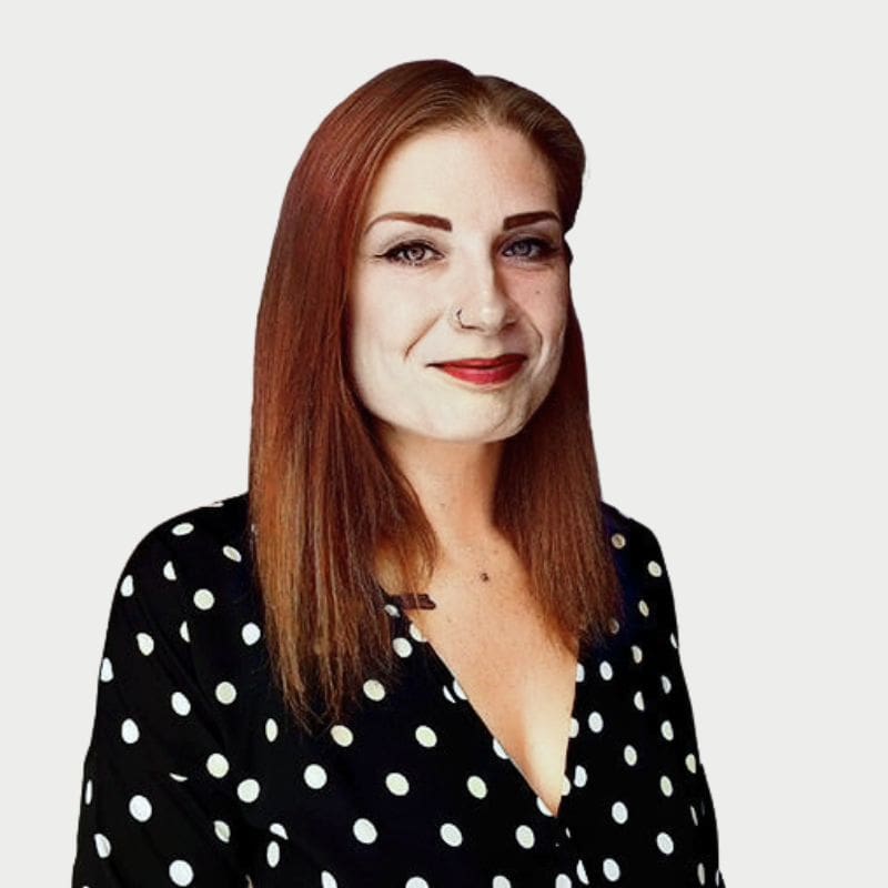 Profile shot of woman with red brown hair and a black and white polkadot top